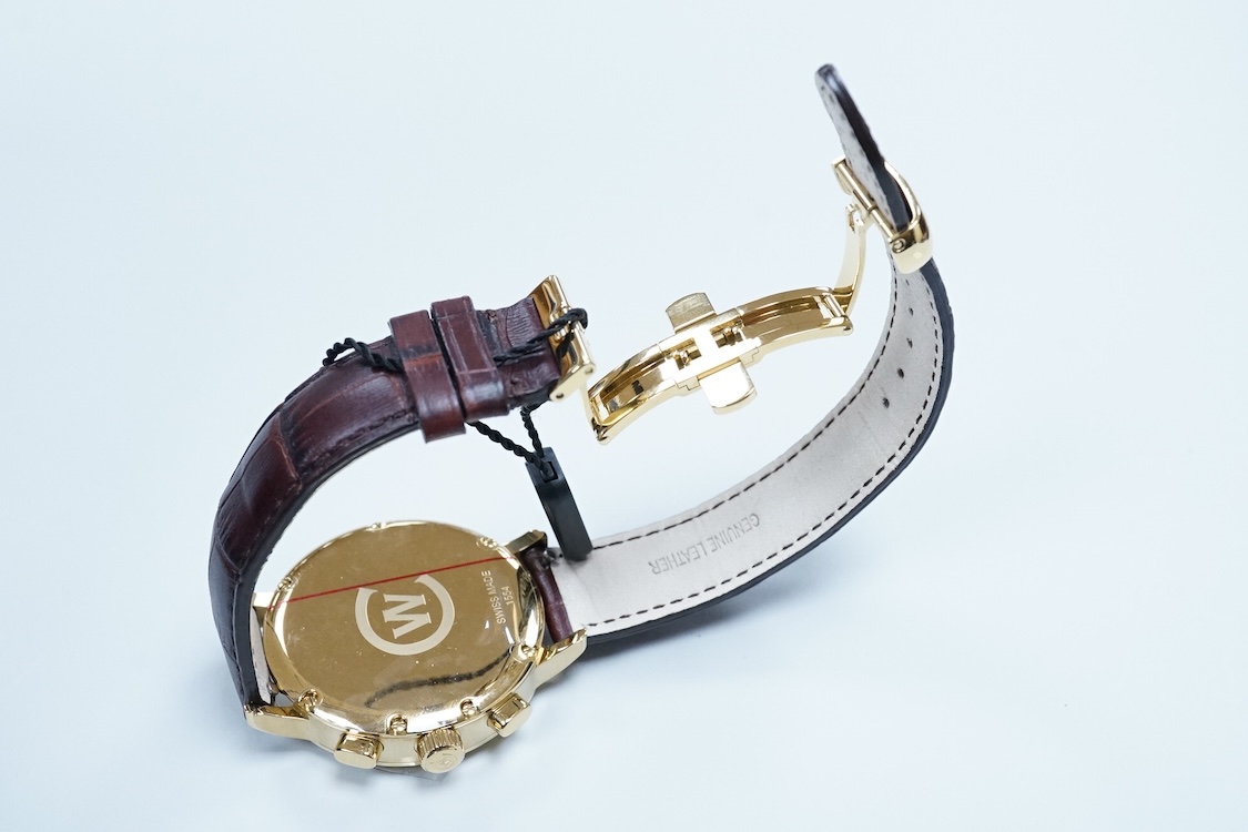 A boxed modern Christopher Ward of London gilt stainless steel chronograph quartz wrist watch, case diameter 40mm, on a Christopher Ward leather strap with deployment clasp, with papers but not for this model.